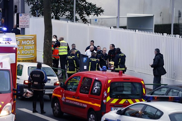 Police, paramedics and firefighters at the scene of the shooting in the south Paris on Thursday, January 8. 