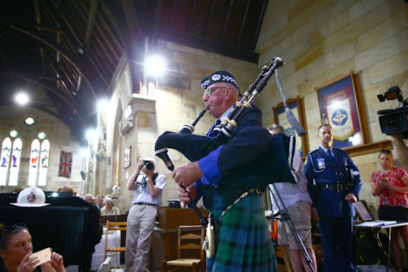 A lone bagpipe played at the memorial service.