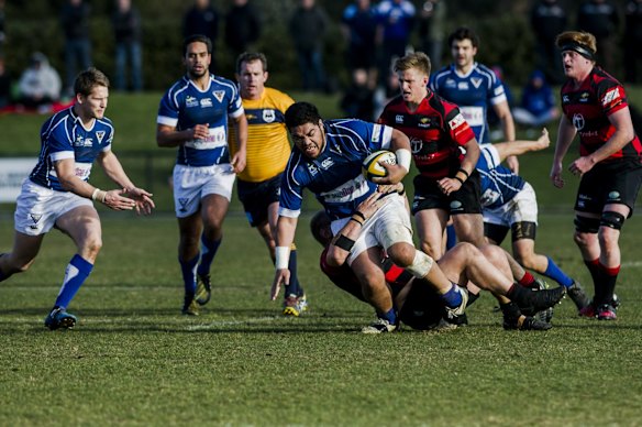 Royals' Steve Sione is tackled by Gungahlin's Ray Dobson.