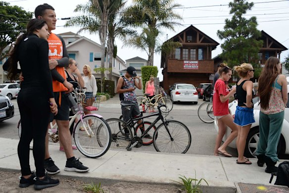 A suspected gunman's car is removed from a crash site, after the drive-by shooting.