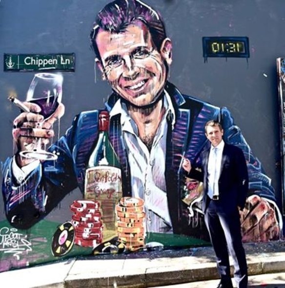Mike Baird in front of graffiti of himself. 