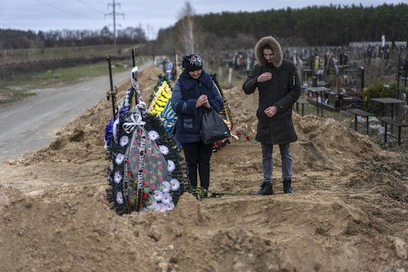 Natalya Verbova, 49, and her son Roman, 23, at the funeral of her husband Andriy Verbovyi, 55, who was killed by Russian soldiers in Bucha.