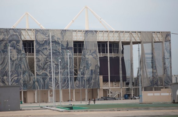 The translucent tapestries created by Brazilian artist Adriana Varejao fall from the exterior of the aquatic stadium in February.