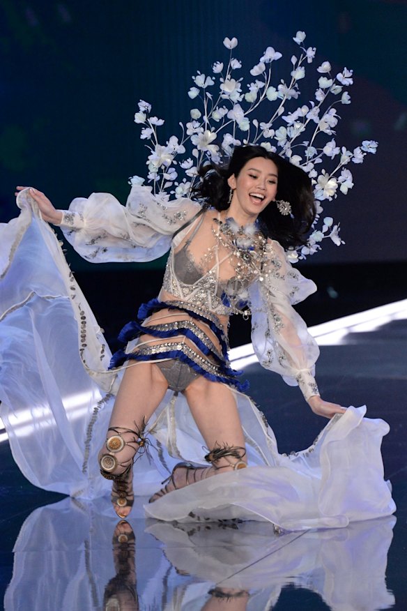 Ming Xi loses her balance on the catwalk for the Victoria's Secret Fashion Show.