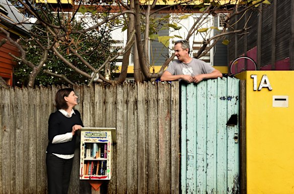 Street librarians Nic Lowe and Kylie Legge at the book exchange outside Lowe's home.