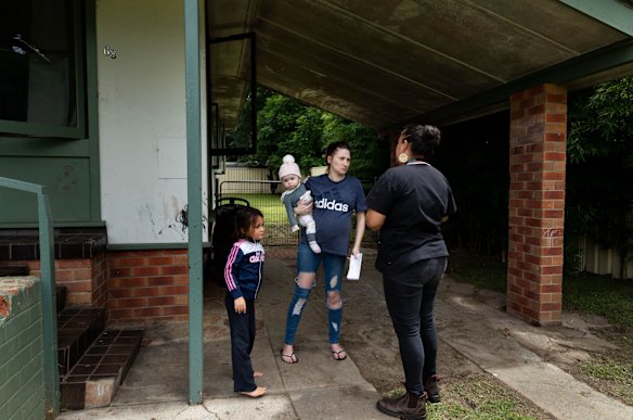 Mel Briggs, visits pregnant mother, Janelle Crump, with two of her eight children, Shakaya, 6, and Amarli, 9 months, at her home in Nowra, NSW.