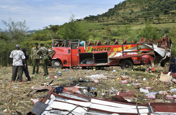 Kenyan police and other rescuers attend the scene of a bus crash near Kericho in western Kenya.