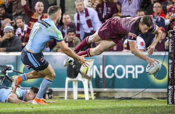 Corey Oates of the Maroons scores a try.