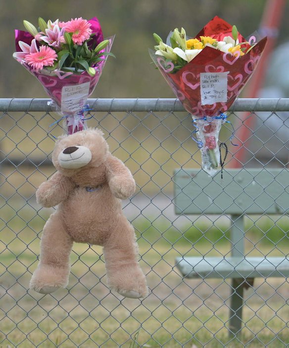 Friends arrive at the Tyabb oval to place flowers.
