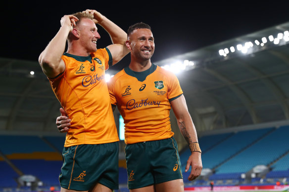 Quade Cooper celebrates with Reece Hodge after kicking the winning penalty.