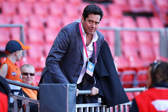 AFL CEO Gillon McLachlan climbs the fence to access the grandstand before the AFL 2nd Elimination Final match between the Greater Western Sydney Giants and the Western Bulldogs at GIANTS Stadium in 2019.