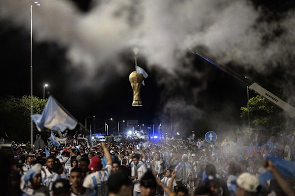 A dummy of the FIFA World Cup trophy hangs at the entrance of the Argentina Soccer Association training grounds where the team that won the Wold Cup will spend the night after landing at Ezeiza airport on the outskirts of Buenos Aires, Argentina.