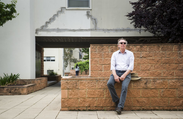 The owners of the Elara apartments, including David Allen, pictured outside the building, are launching federal court action against the builders insurance fund. 