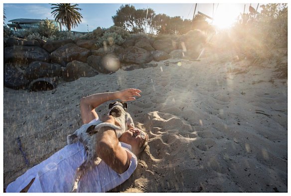 Miss Maudie flicking sand everywhere as she jumps on Neil.