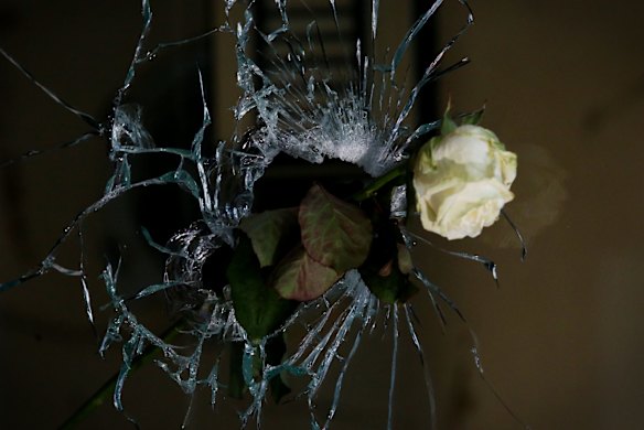 A rose in a bullet hole at La Belle Equipe in Paris, France.