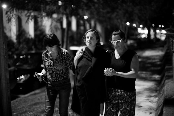 Sally Walsh, goes for a midnight walk, supported by her friend, Angela Topping, left, and her doula, Nadine Waldbaum, right, during her labour at home. before going into the Royal Hospital for Women in Randwick, Sydney. 