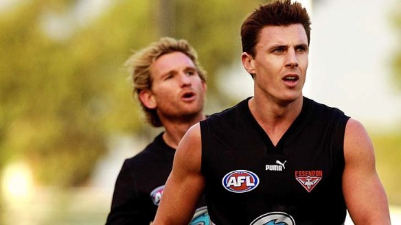 Matthew Lloyd (front) has backed the bid by former premiership teammate James Hird to return as Essendon coach. 