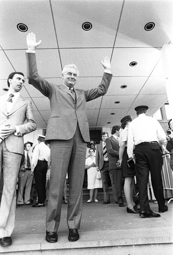 Gough Whitlam with hands raised greets crowd on steps of Parliament House, 1975