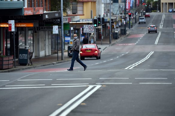 Shoppers walk on Moore Street in Liverpool, as COVID restrictions tighten across Sydney.
