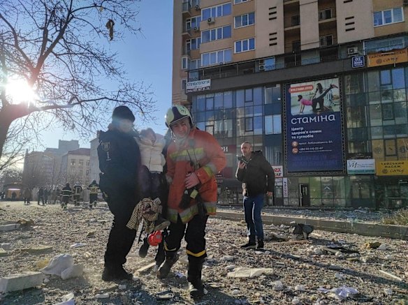Emergency services evacuate the wounded after a shell hit a multistorey residential building in Kyiv.