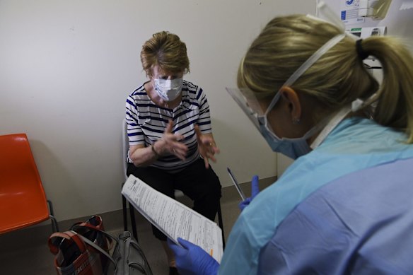 Nurse Louise Mason does a patient assessment with Frances Callen who is being tested for coronavirus.