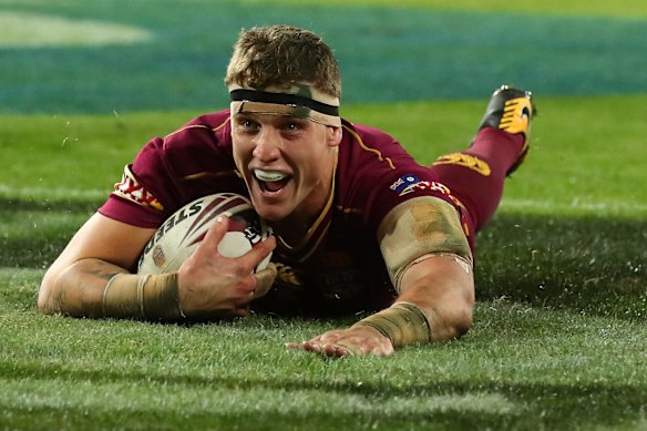 Jarrod Wallace of the Maroons dives to score a try.
