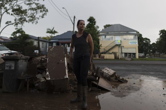Crystal Dwight stands among the devastation in Lismore. Access to the area has is only now possible for emergency services, with the massive cleanup effort just beginning for local residents.