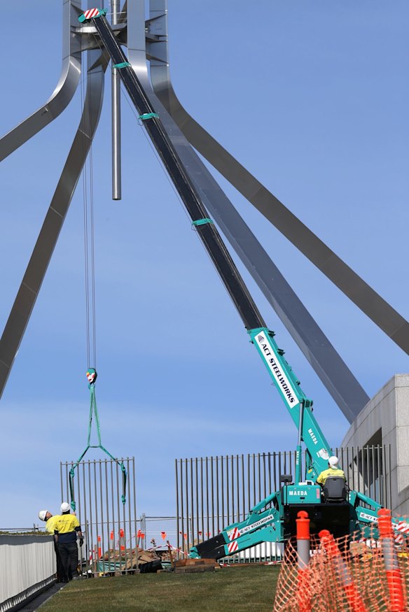 A security fence is installed across the lawns of Parliament House.