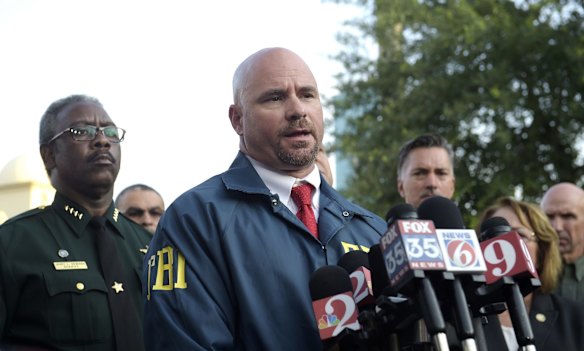 FBI assistant special agent in charge Ron Hopper, center, answers questions from members of the media after a fatal shooting at Pulse Orlando nightclub.