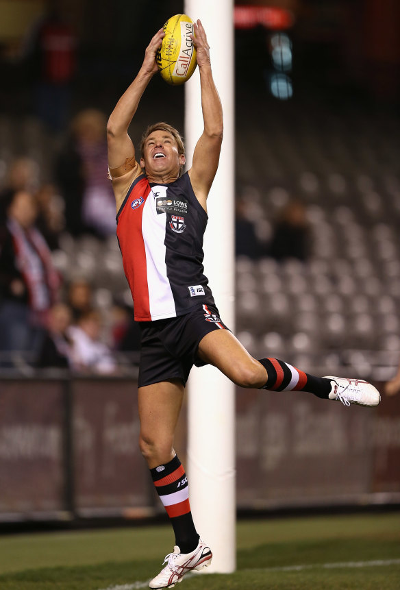 Shane Warne takes a mark during an Australian Rules charity match in 2012.