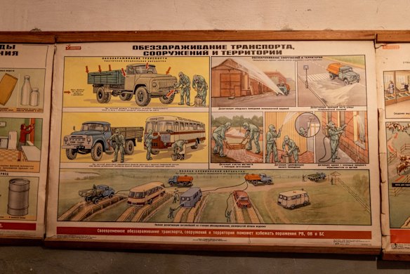 An old safety poster inside a Kyiv bomb shelter shows instructions on how to deal with a chemical or nuclear attack.