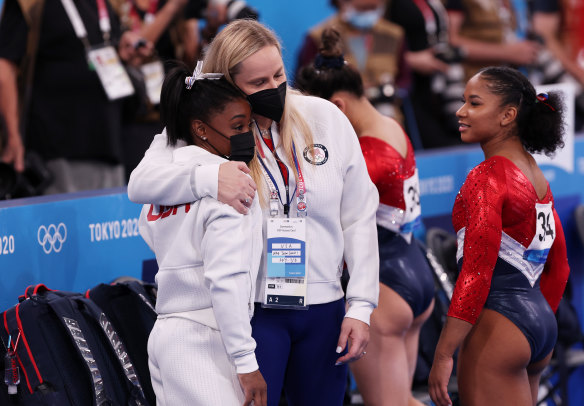 Simone Biles is consoled by American coach Cecile Landi after pulling out of the team final.