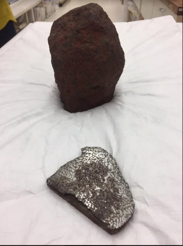 One section of the Georgetown meteorite has been sawed through to show nickel-iron encased in broze coloured iron sulphide.