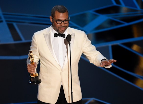 Jordan Peele accepts the Oscar for best original screenplay for <i>Get Out</i>.
