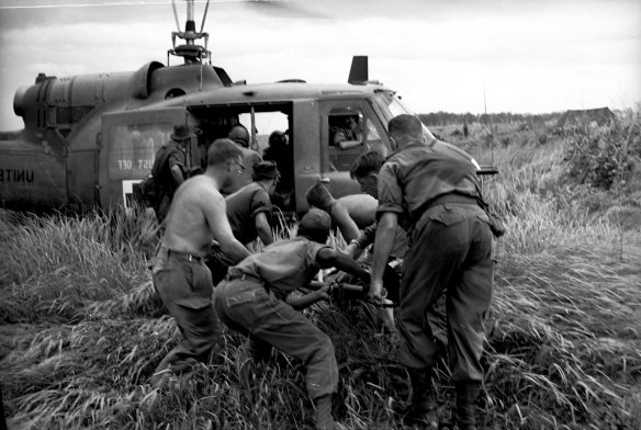 A wounded 1st Battalion soldier is lifted into Medi-vac helicopter after the accident on June 26, 1965.