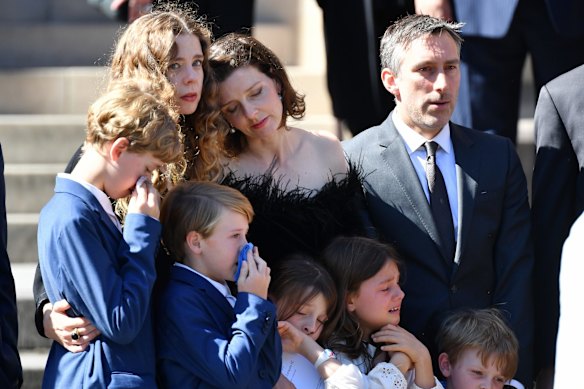 Carla Zampatti's daughters Bianca and Allegra Spender with their children outside St. Mary's Cathedral after the funeral service. 
