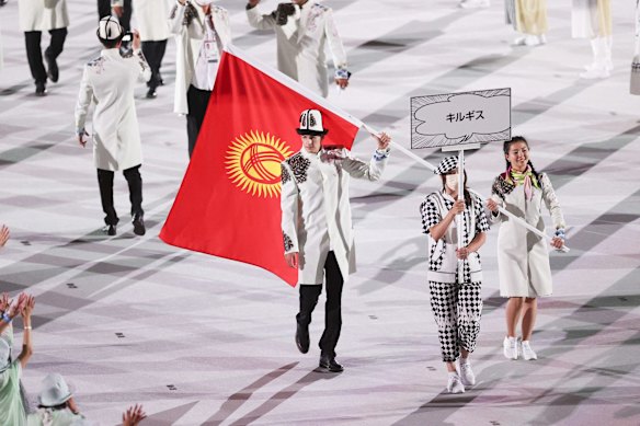  Flag bearers from Team Kyrgyzstan who paraded maskless.