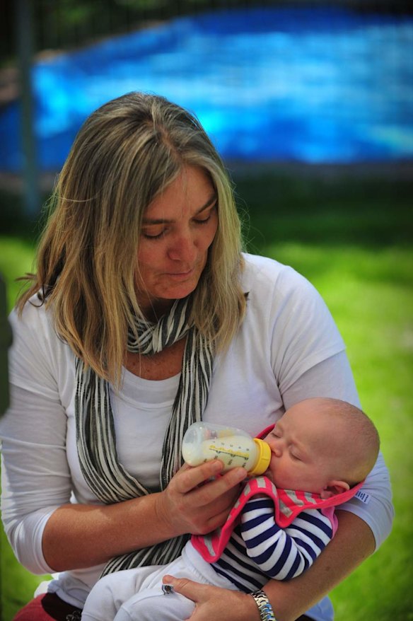 Canberra Capitals coach Carrie Graf, with partner Camille Chicheportische and baby twins Bentley (blue and yellow top) and Charli (blue and pink top).