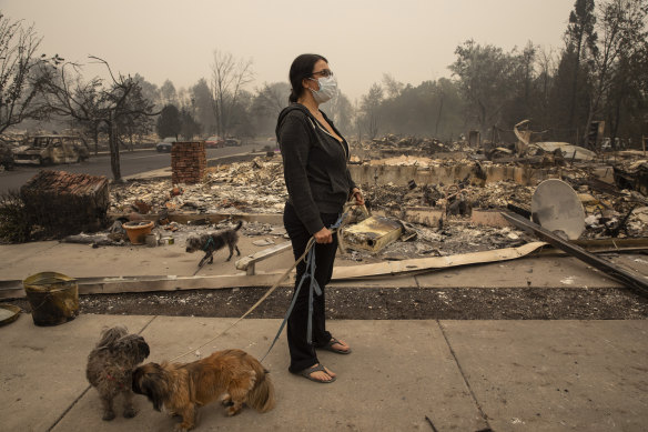 Lexi Sovllios from Talent, in Oregon, stands amid the ruins of her home.