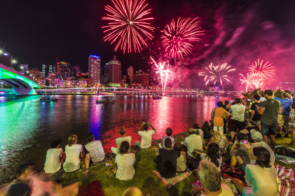 Revellers enjoying the fireworks from South Bank on New Year’s Eve in Brisbane.
