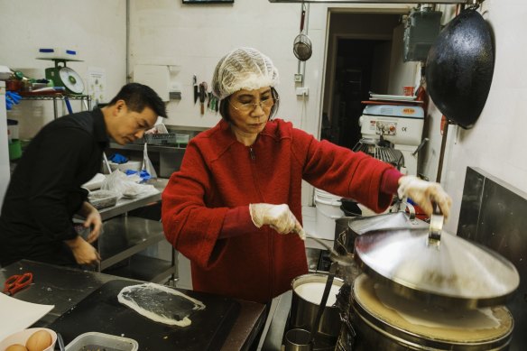 At the Banh Cuon Vietnamese shop, Anthony Dinh with his mum Kim Thanh prepare dishes.
