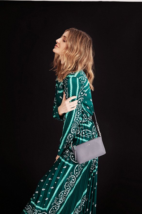 Sandro shirt, $440, and “Mercedes” skirt, $550, from David Jones. Calvin Klein “Hayden” crossbody bag, $170, from David Jones.