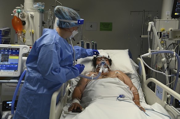 ICU Registered Nurse Shaunagh Whelan (left) attends to a COVID-19 positive patient.