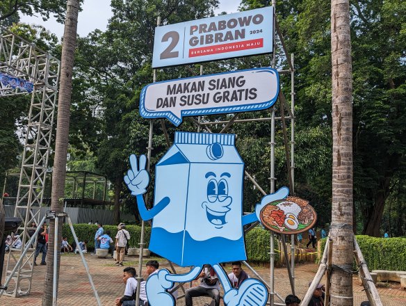 “Free lunch and milk”: An election campaign poster outside a Prabowo Subianto rally before the February election. 