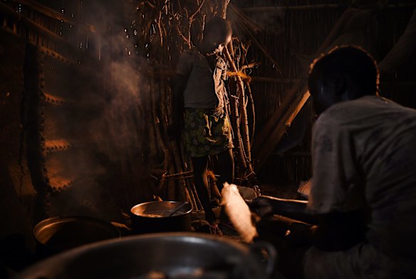 A mother and child prepare a meal in their shelter inside the UN Bentiu Protection of Civilians (POC) site, Bentiu, Unity State, South Sudan. 