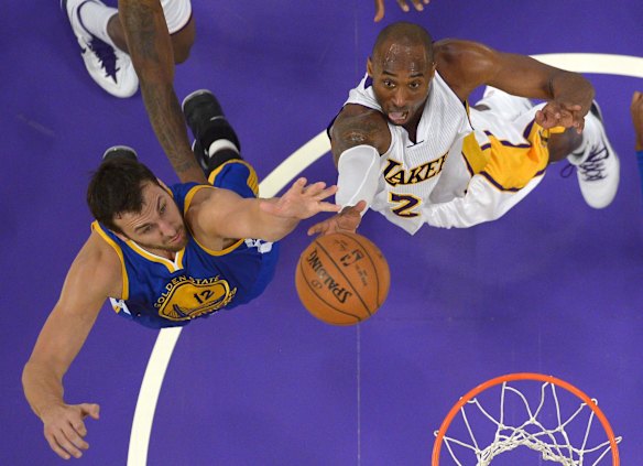 2014: Los Angeles Lakers guard Kobe Bryant puts up a shot as Golden State Warriors center Andrew Bogut of Australia defends. 