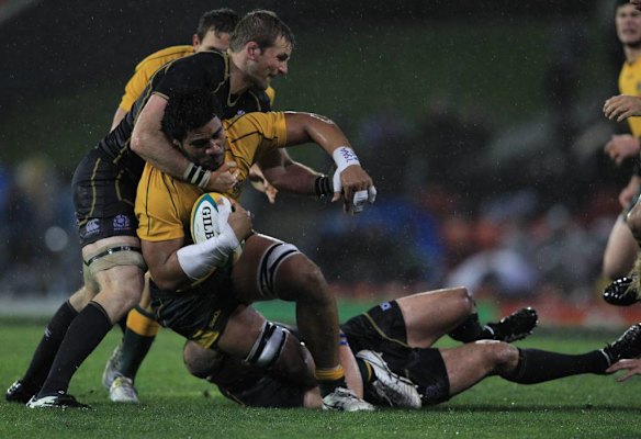 Sitaleki Timani is hit with some committed Scottish defence.