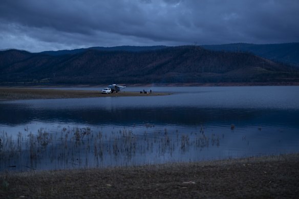 Campers on the edge of Bowering Dam, on the edge of Bogong Peaks. The Dunns Road fire impacted the area in mid January. The Dunns Road fire was believed to have been started by a lightning strike on the 28th of December in a private pine plantation near Adelong, and by the 11th of January three fires had merged – the Dunns Road fire, the East Ournie Creek, and the Riverina's Green Valley fire.