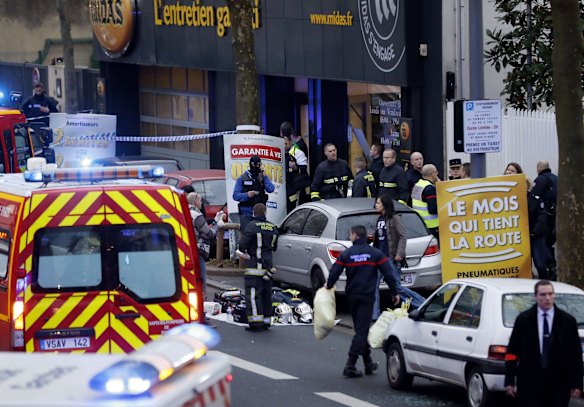 Police, paramedics and firefighters at the scene of the shooting in the south Paris on Thursday, January 8. 