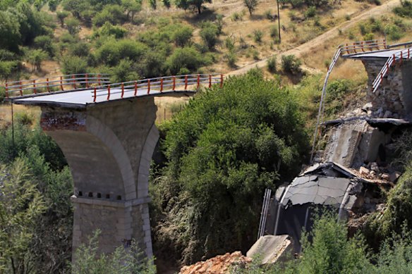 A destroyed bridge is seen next to Talca.